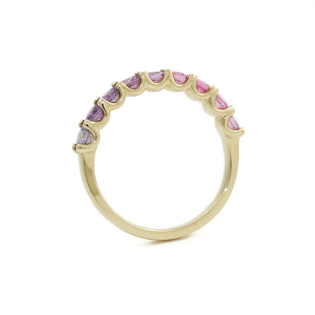 Indulge in the beauty of this Pink Sapphire band, skillfully crafted in 14K Yellow Gold. These pinky/ purple sapphires have been expertly cut into alluring round shape, enhancing their brilliance and color saturation. The 14K yellow gold band provides a radiant and complementary setting, accentuating the sapphires' natural beauty in a bead setting.