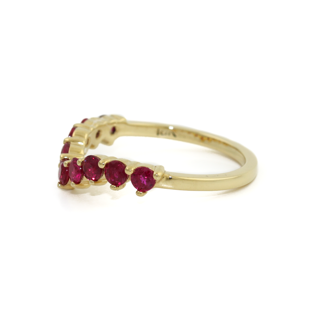 A gorgeous band comprised of 9 round cut rubies, aligned in a chic tiara shaped setting. Set in 14k yellow gold, the vibrant rubies truly pop. Each Ruby is set with a prong bezel allowing you to see each stone in full dimension. All together the elements work beautifully as the crowning jewel band to your existing set, or a modern standalone piece. This isn't your run of the mill stacking band! Made by Kingdom Jewelry using Rubies and 14k Yellow Gold