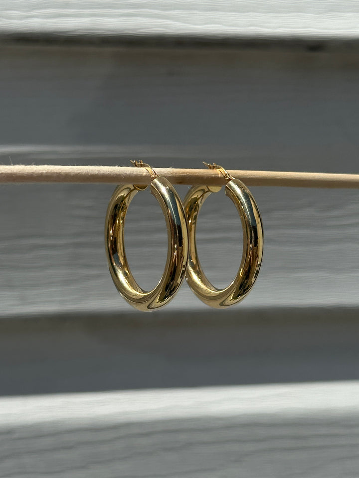 Butter up your jewelry collection with our must-have Chunky Hoop Earrings. Crafted from fine 18k yellow gold, these hoops are as radiant as they come. Designed to be your favourite everyday piece, they're perfect for adding a dash of luxe to any look.