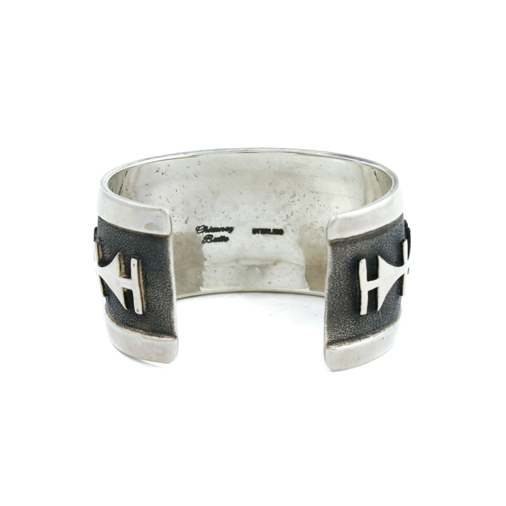 
                      
                        Experience the rich cultural heritage and exquisite craftsmanship of the Hopi people with our Vintage Silver Hopi Overlay Bangle Bracelet. Each bangle is a masterpiece, a testament to the artistry and traditions that have been passed down through generations.
                      
                    