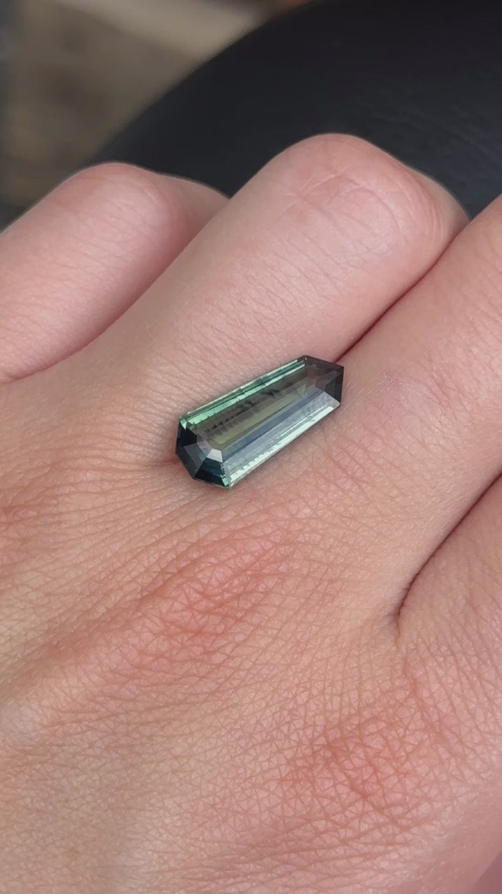 Discover the allure of this utterly exquisite 5.44ct shield-cut deep green sapphire, perfect for becoming the centrepiece of your dream jewelry. Its mesmerizing facets capture a spectrum of rich forest tones, making it an exceptional and unique gemstone.