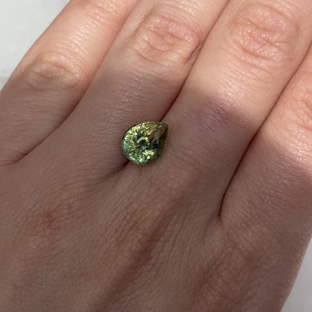 
                      
                        Load and play video in Gallery viewer, Create the ring of your dreams with this 3.75ct pear-shaped Parti sapphire. This utterly stunning gemstone catches sunny champagne and brilliant fern green tones within its facets, making it a truly one-of-a-kind gemstone.
                      
                    