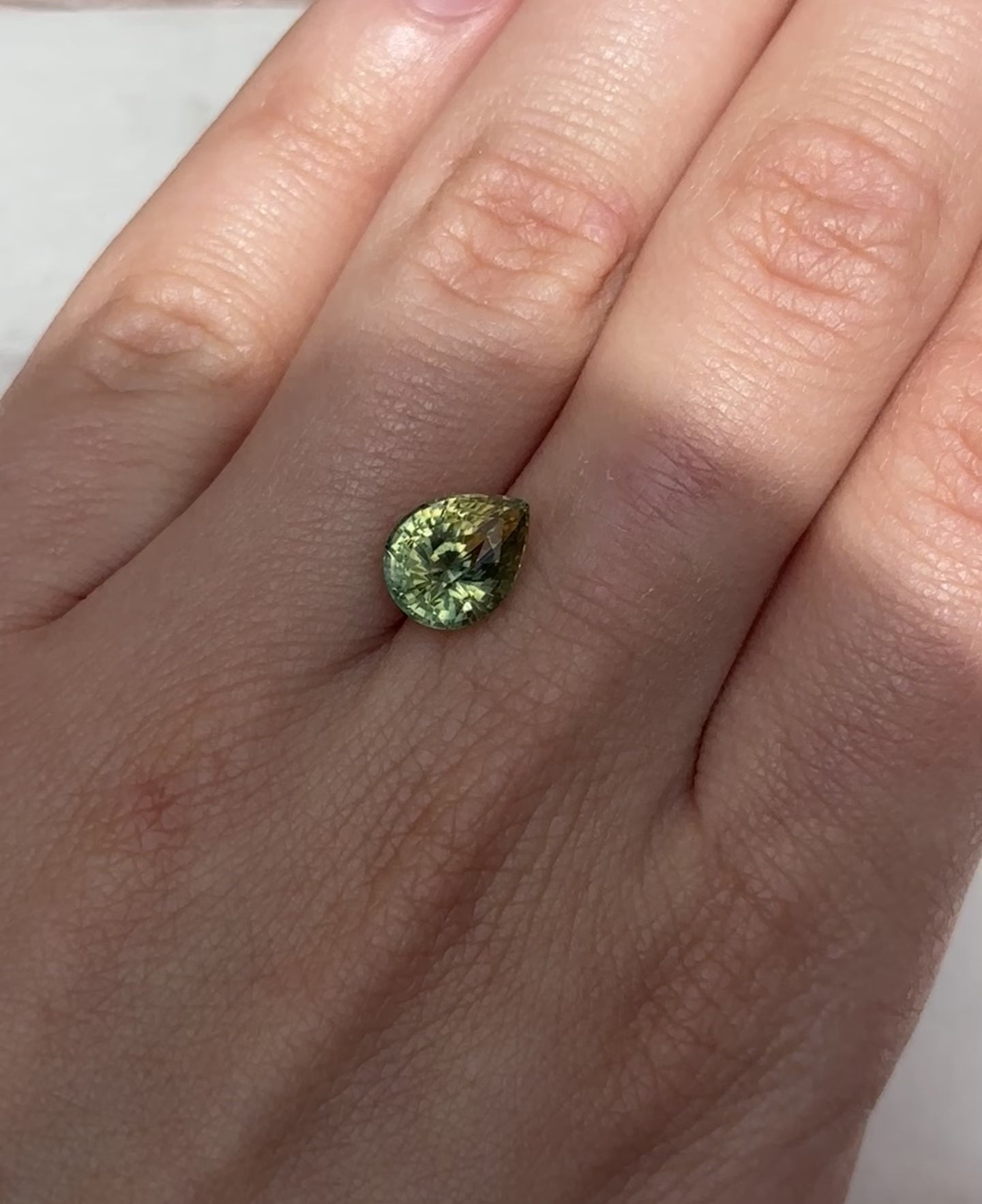 Create the ring of your dreams with this 3.75ct pear-shaped Parti sapphire. This utterly stunning gemstone catches sunny champagne and brilliant fern green tones within its facets, making it a truly one-of-a-kind gemstone.