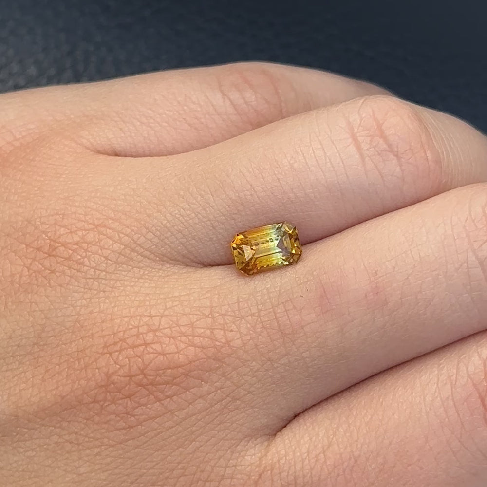 
                      
                        Load and play video in Gallery viewer, Create the ring of your dreams with this 2.06ct emerald-cut Madagascar parti sapphire. This utterly stunning gemstone is natural and unheated, catching rich sunflower yellow and brilliant fern green tones within its facets, making it truly one-of-a-kind.
                      
                    