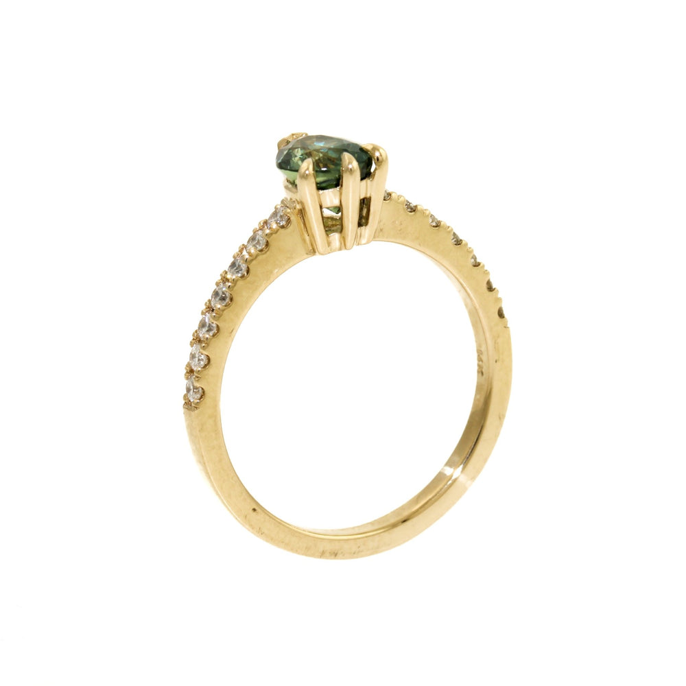 
                      
                        An alluring seafoam green sapphire, cut in the shape of a teardrop to flatter and elongate the finger. This beautiful stone is set in a 14k gold bezel, surrounded by brilliant tiny diamonds.
                      
                    