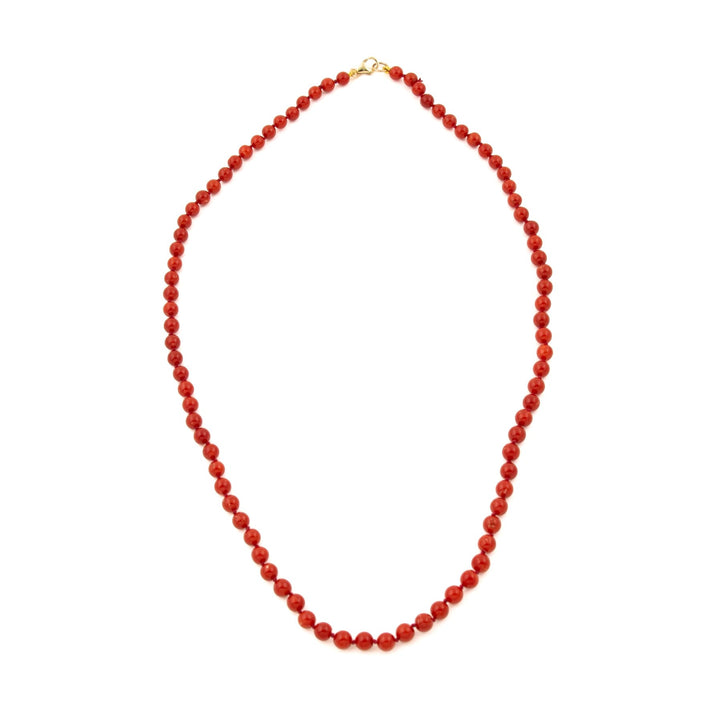 This exquisite antique beaded coral necklace is a timeless piece of jewelry that is sure to become your favourite accessory. Strung by hand, the necklace features a string of vibrant coral beads with a 10-carat gold clasp, creating a stunning combination of classic beauty and modern elegance
