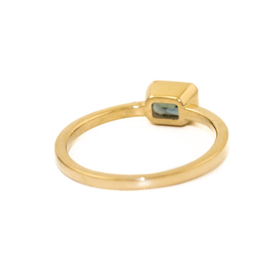 Load image into Gallery viewer, Gorgeous classic sapphire ring made by Kingdom. The emerald cut Montana sapphire is held in a claw 14 karat gold setting. Crafted with passion and detail in-mind, our new &amp;quot;Engagement&amp;quot; series aims to create timeless pieces to be cherished and admired over a lifetime.
