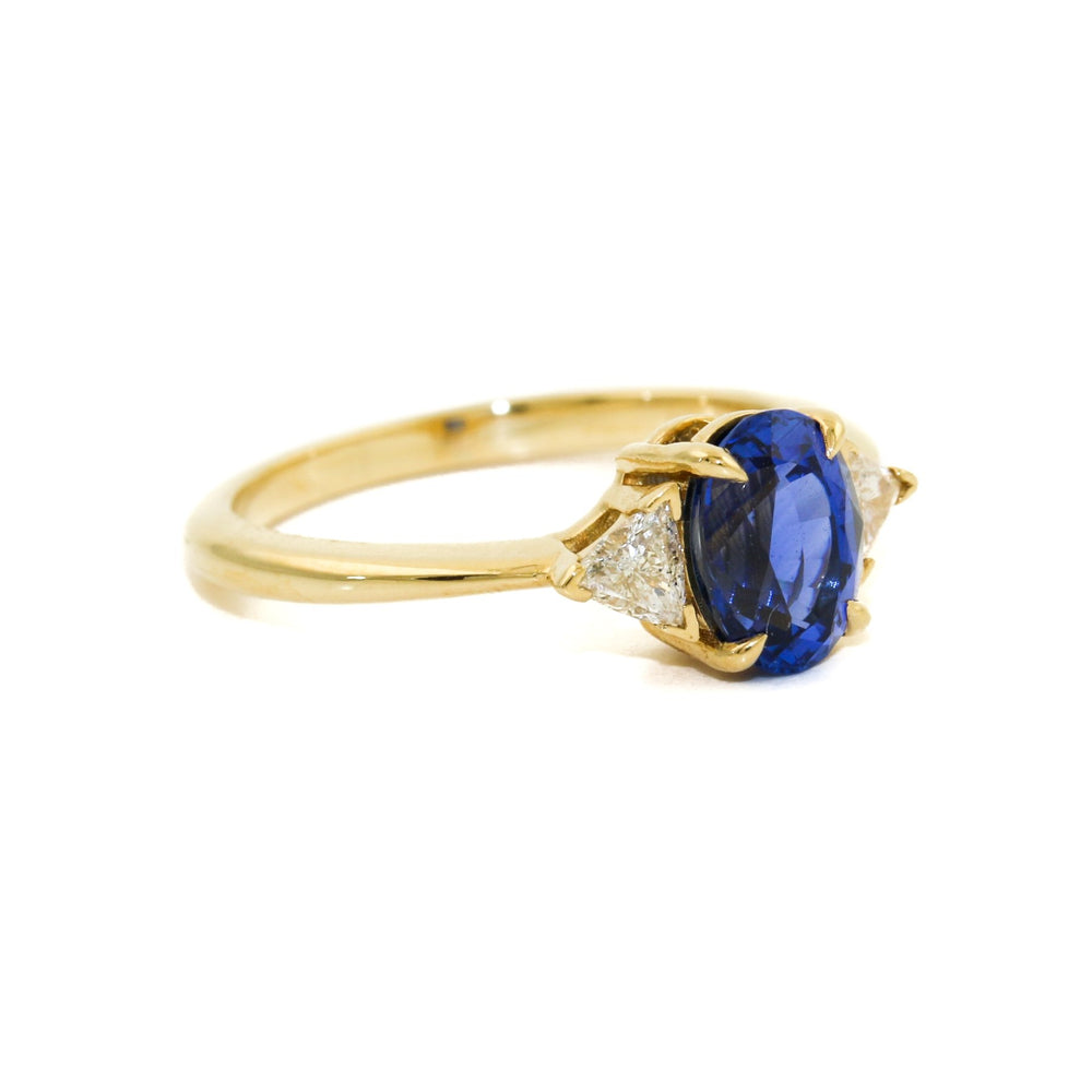 
                      
                        Introducing our breathtaking royal blue Montana sapphire ring with triangle cut diamonds set in 18k gold, a true masterpiece of beauty, luxury and elegance.
                      
                    