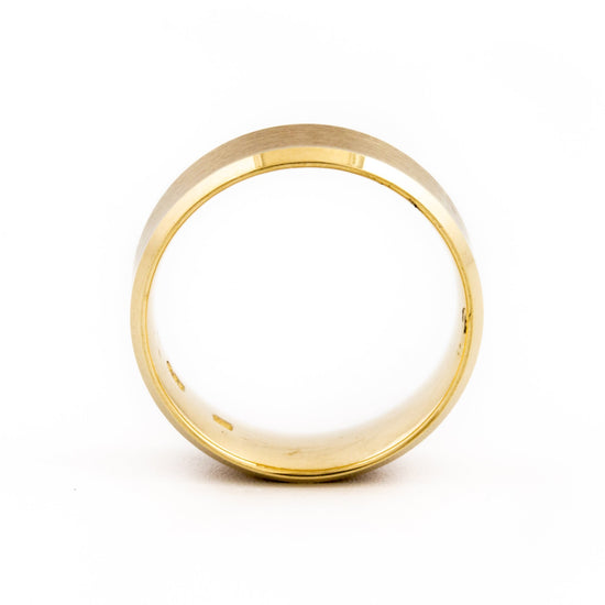 This clean modern ring is a refined and contemporary wedding band, featuring a recessed edge contrasting a brushed and shiny edge. The textured angled design gives it a modern feel and makes for a comfortable ring.